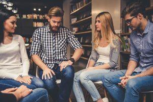 two men and two women meet in the library of a benzo addiction rehab center