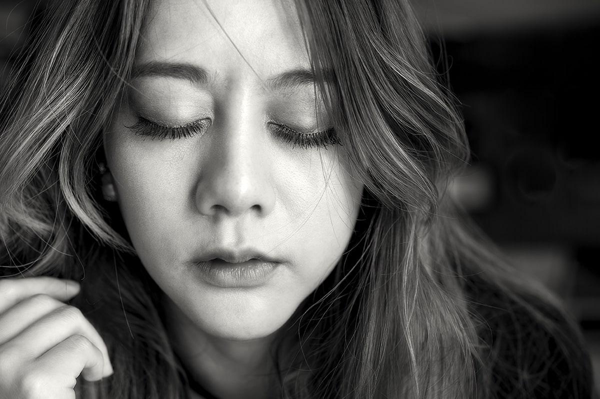 depression and anxiety, black and white close up of woman with eyes closed
