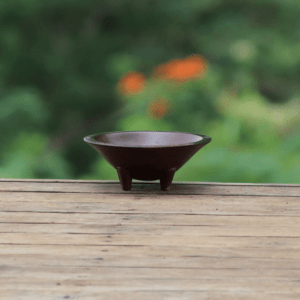 kava in a metal bowl on table outside